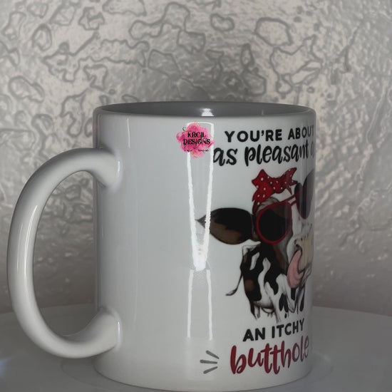 Funny Coffee Mugs by Krcil Designs | A white ceramic mug and sassy quotes on both sides of the mug. Graphic Design: a black and white spotted cow wearing a red and white polka dot bow and sunglasses. Front Side: text that reads: "You're About as Pleasant as an Itchy Butthole" Back Side: text that reads: "Sorry Sarcasm Falls Out Of My Mouth Like Stupidity Falls Out Of Yours" | Shop Coffee Mugs at KrcilDesigns.com