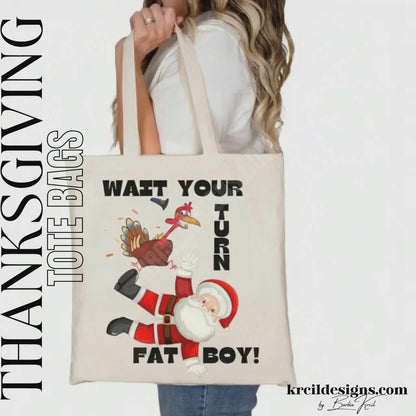 Thanksgiving Funny Tote Bags by KrcilDesigns.com | Graphic design on a canvas tote bag, featuring a cartoon Thanksgiving turkey wearing a pilgrim hat, stomping on Santa Claus, with playful motions and feathers flying. Bold black text in all caps, surrounds the scene, that reads: "WAIT YOUR TURN FAT BOY!" Fun holiday shirts that blend Thanksgiving and Christmas humor.