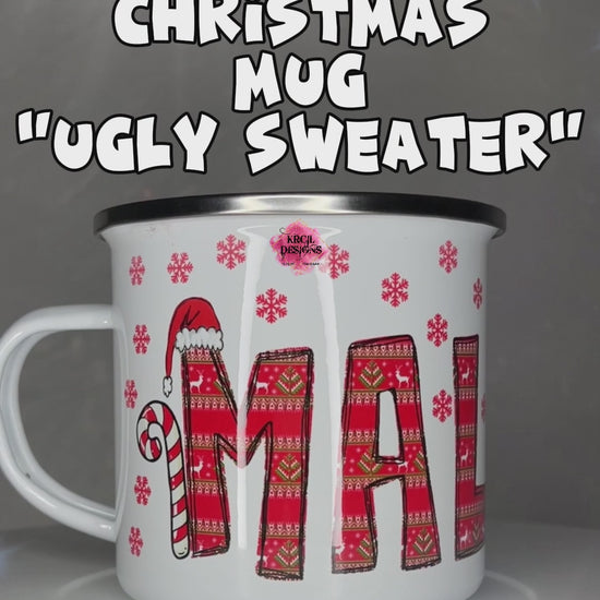 Personalized Christmas Mugs by KrcilDesigns.com | A video of our camp mug, graphic design features your name, in name style option: "Ugly Sweater" where all letters are the same festive design in an ugly sweater pattern. The letters, one adorned with Rudolph's Red Nose, Reindeer Antlers, plus, Santa Hats and Candy Canes on each side of your name.